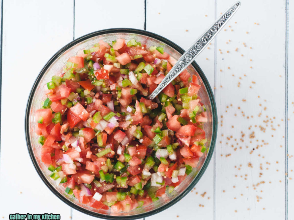 top down view of the Pico de Gallo in a bowl with a spoon in it.