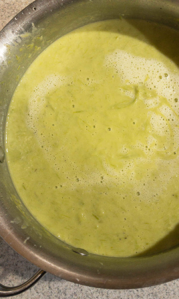 Creamy asparagus soup in pan.