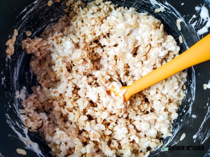stirring Rice Krispy mix in pan.