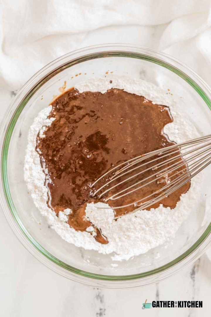Bowl with flour, salt, and melted chocolate mix in it.