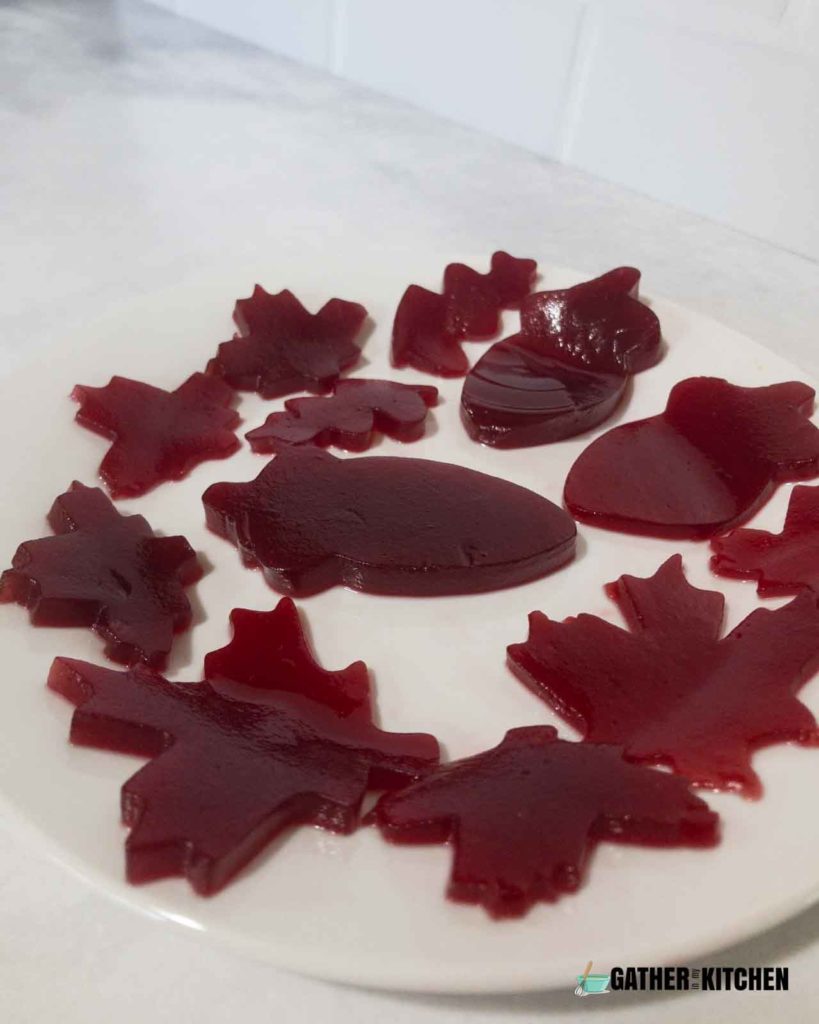 A plate with cranberry sauce cut into shapes.