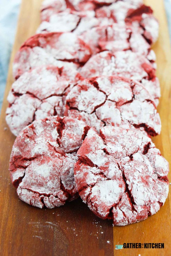 Red Velvet Crinkle Cookies  on a cutting board.