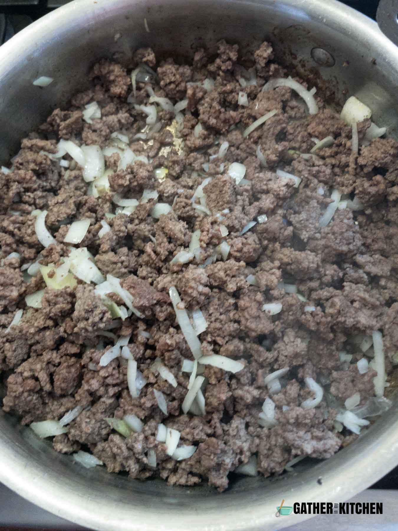 Cooking ground beef, with onions and garlic.