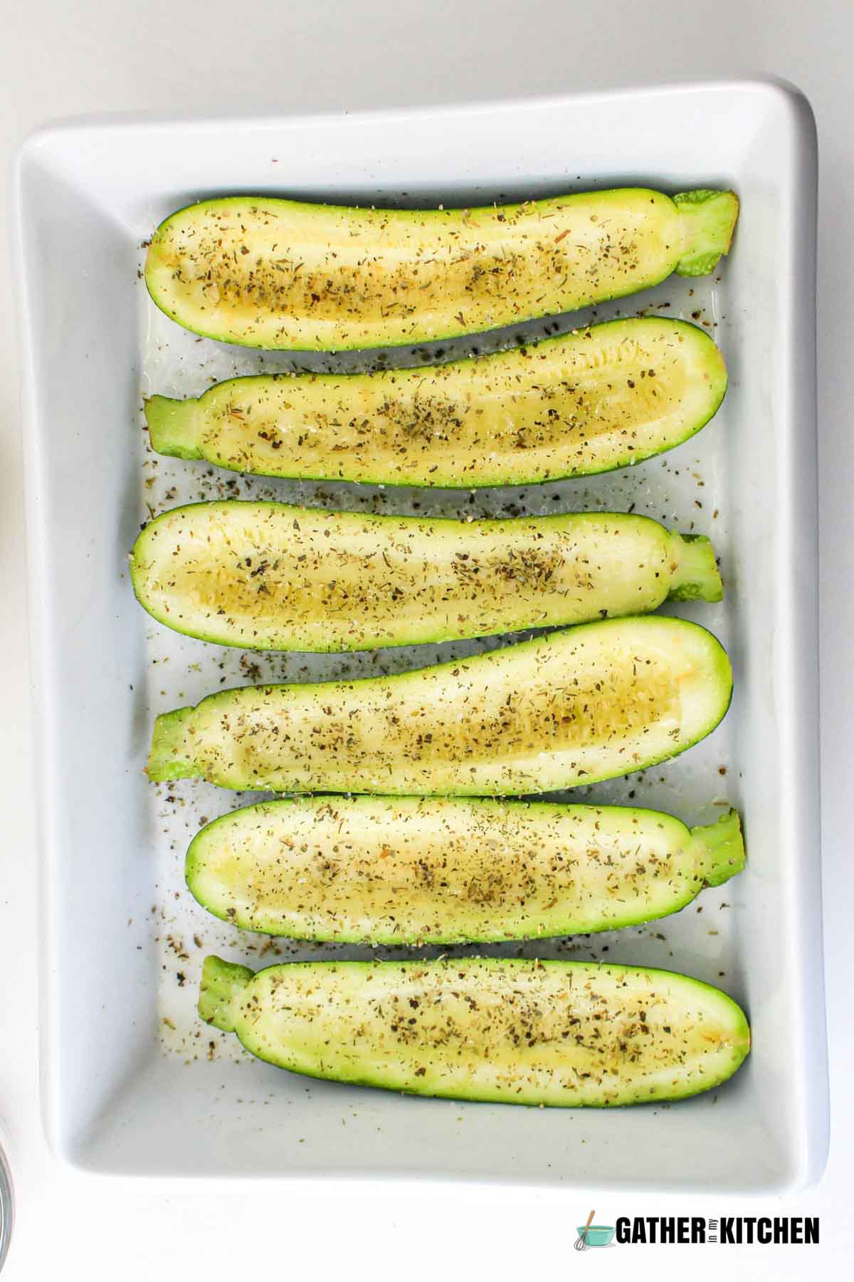 Zucchinis drizzled with olive oil and sprinkled with salt and pepper.