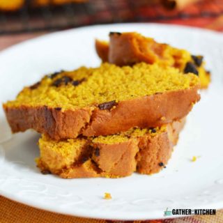 Couple slices of Chocolate chip pumpkin bread stacked on a plate.