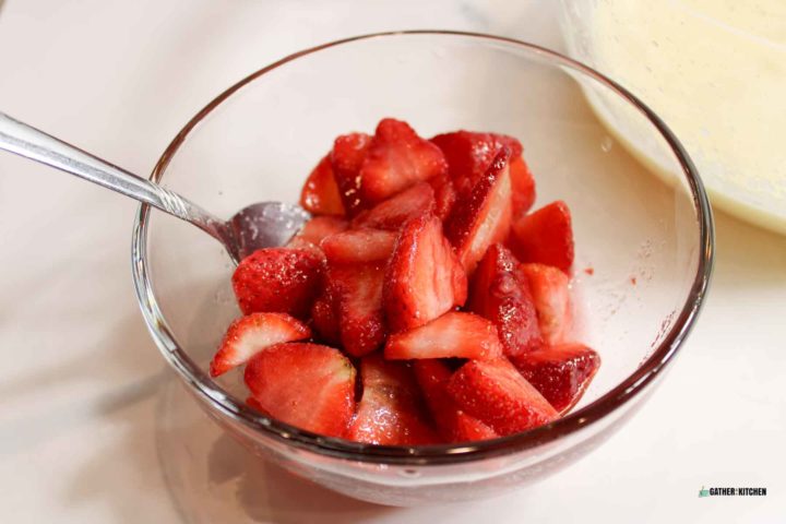 Sliced strawberries in a bowl.