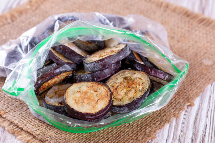 Frozen eggplant slices in freezer bag.