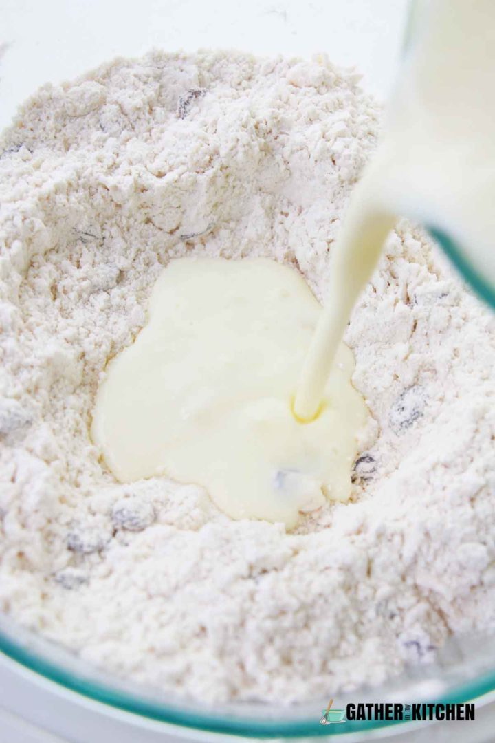 Egg mix being poured into flour mixture.