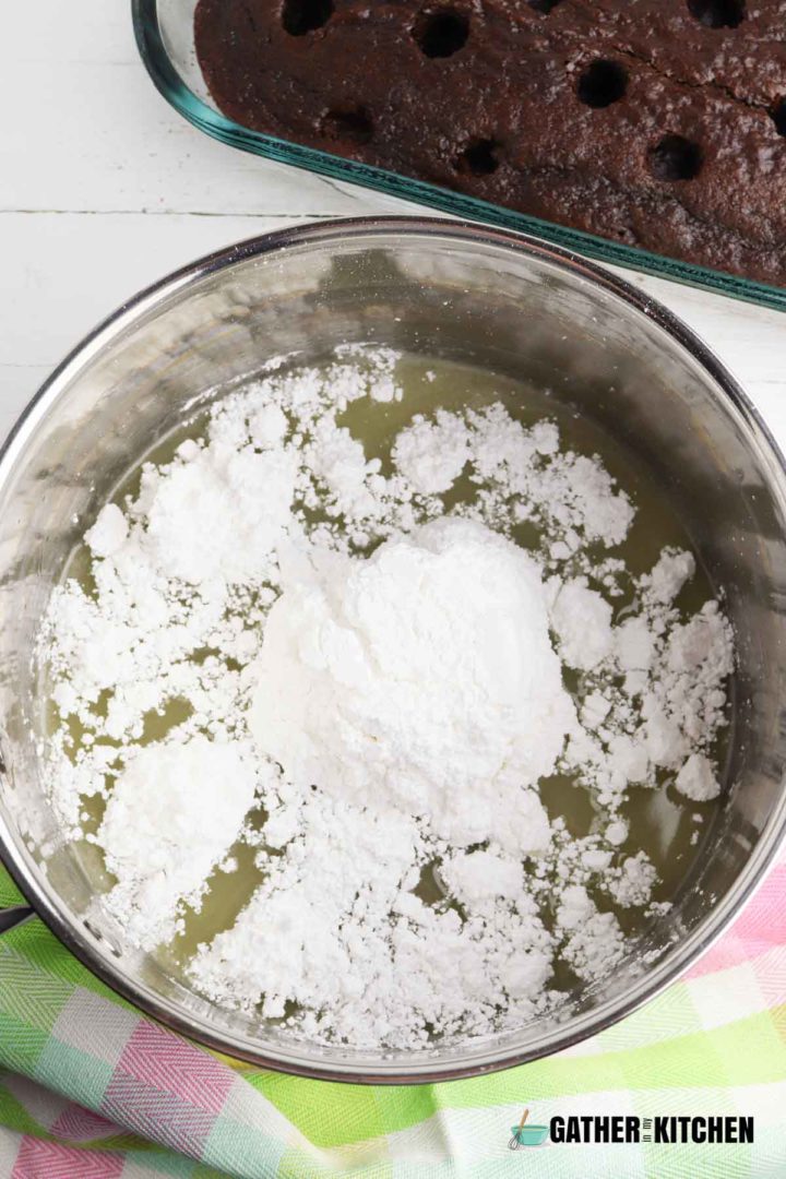 Powdered sugar being added to pan of filling.