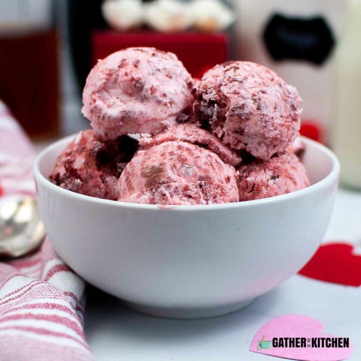 Side view of red velvet ice cream scoop in a bowl.