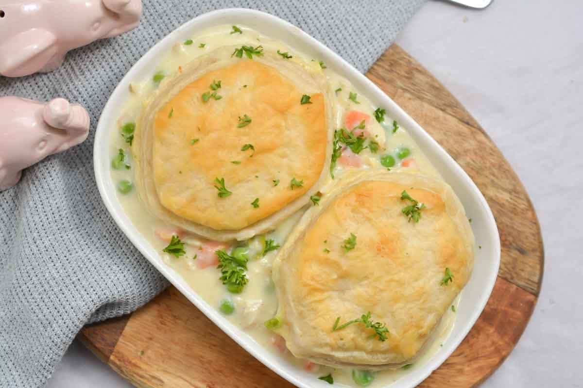 Top down view of chicken pot pie with biscuits on a plate.