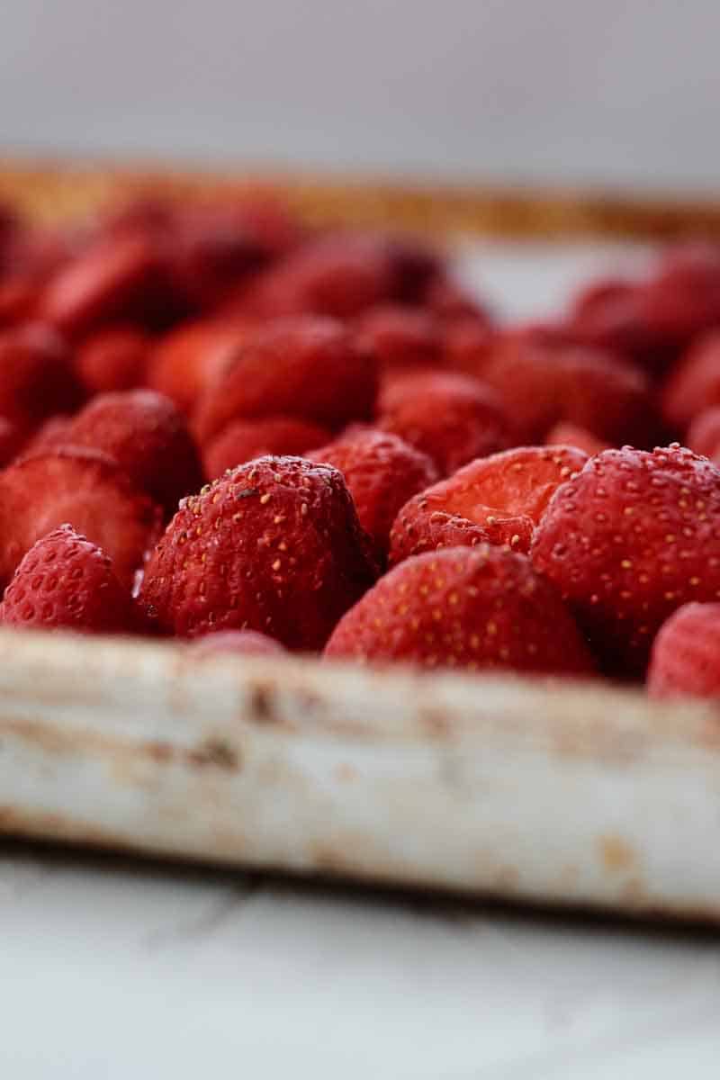 Frozen strawberries on sheet pan.