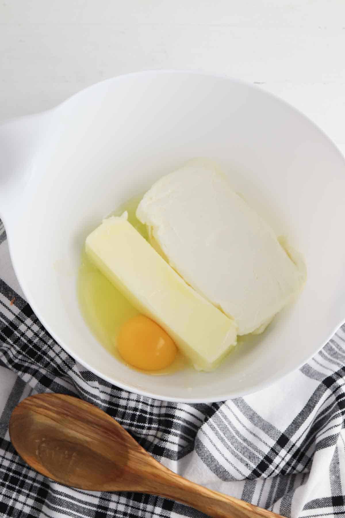 butter, egg, lemon extract, and cream cheese in a bowl.