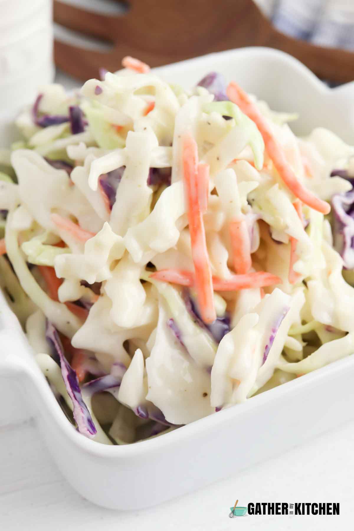 Closeup of coleslaw in a square white dish.