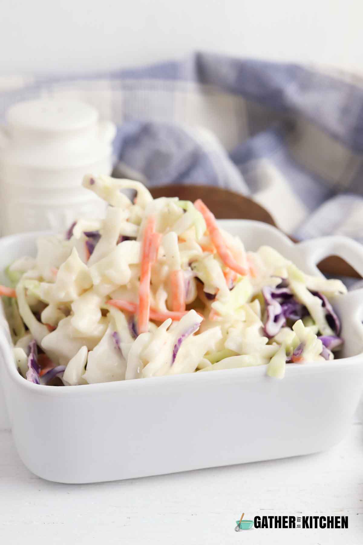 Coleslaw in serving dish side view.