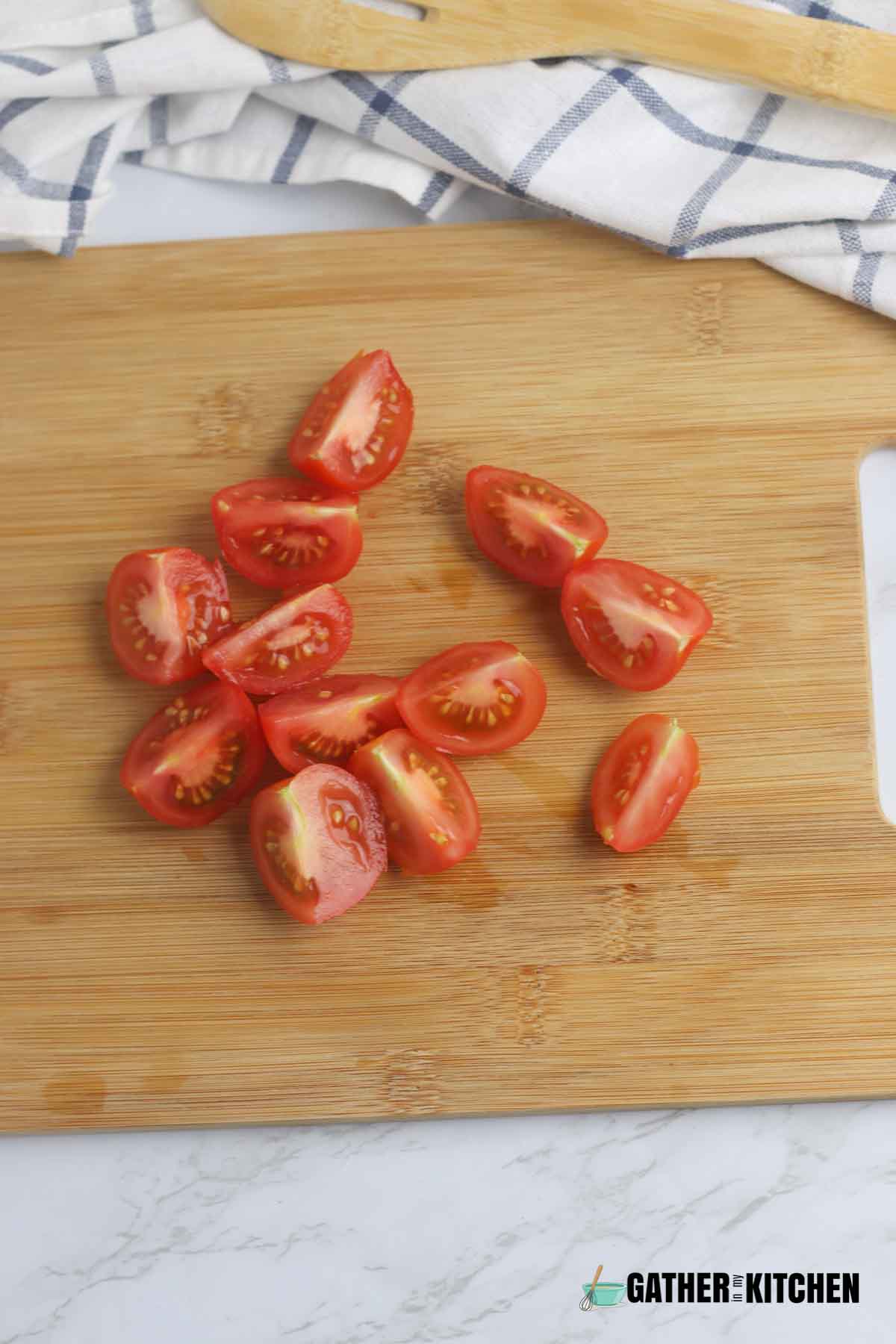 Roughly chopped tomatoes on cutting board.