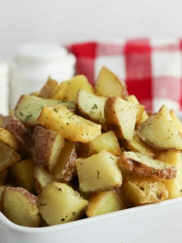Skillet fried potatoes in a dish.