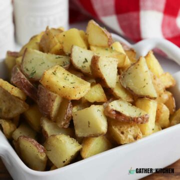 White bowl with a huge pile of fried potatoes in it.