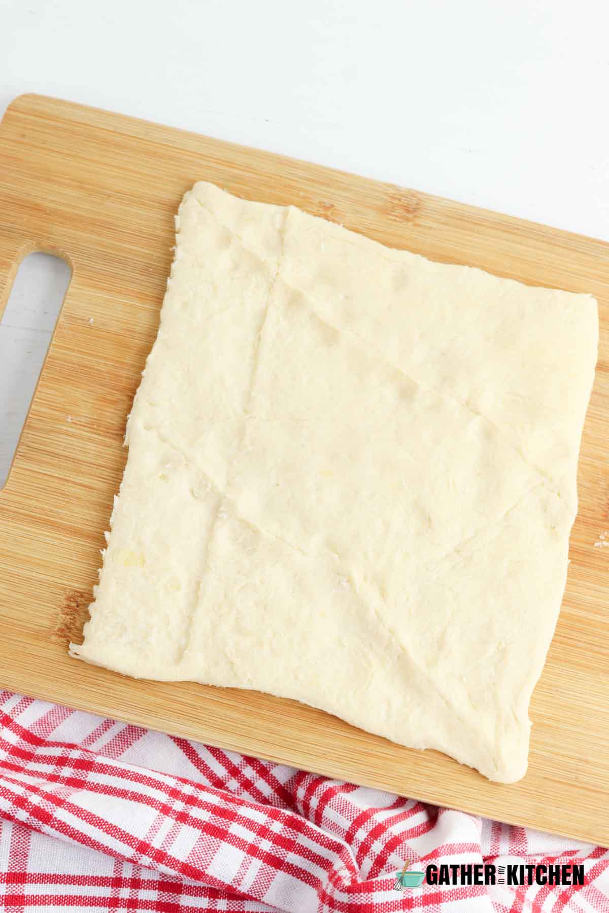 Crescent dough square with seams pinched together.