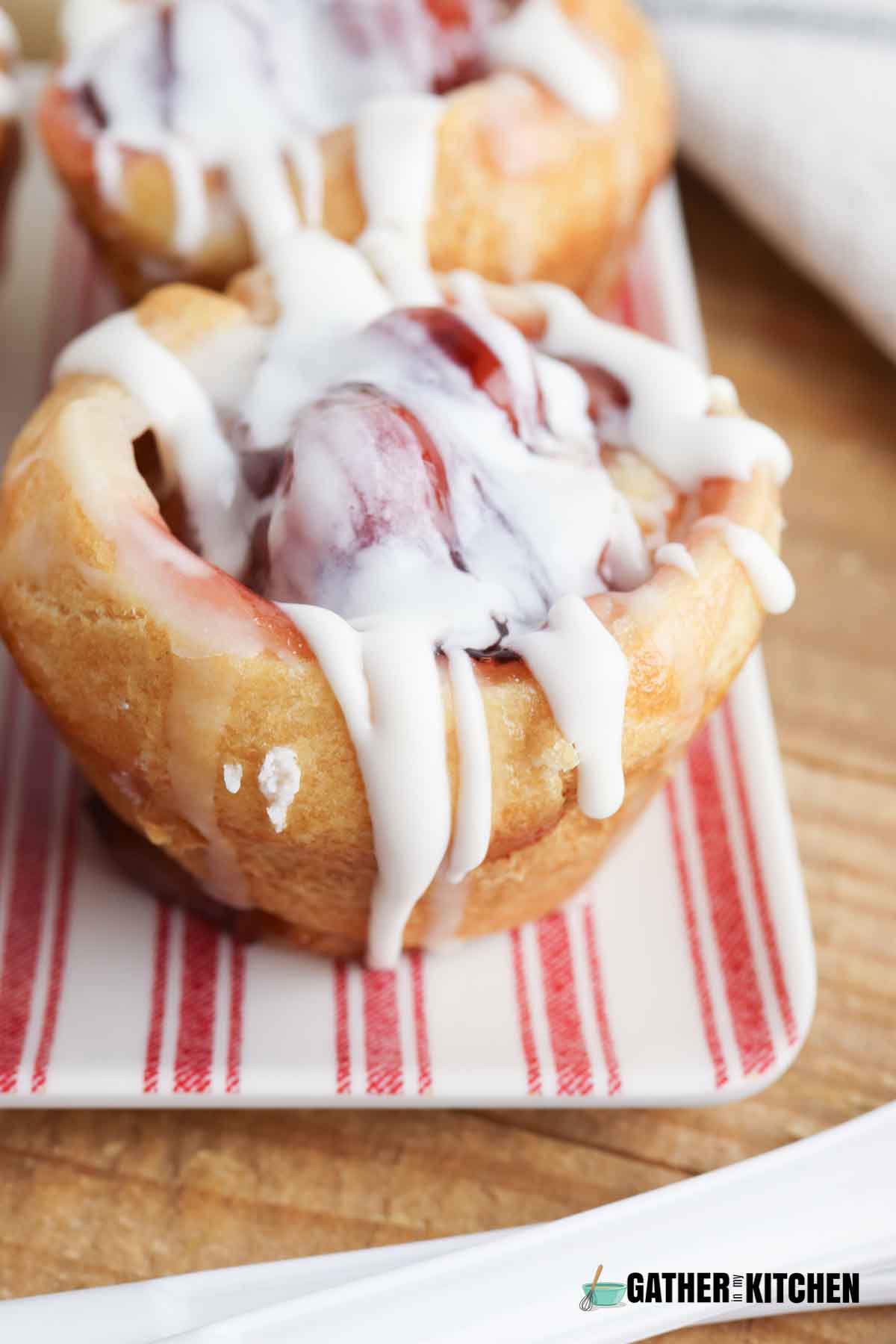 Side view of glazed cherry Danish muffin.