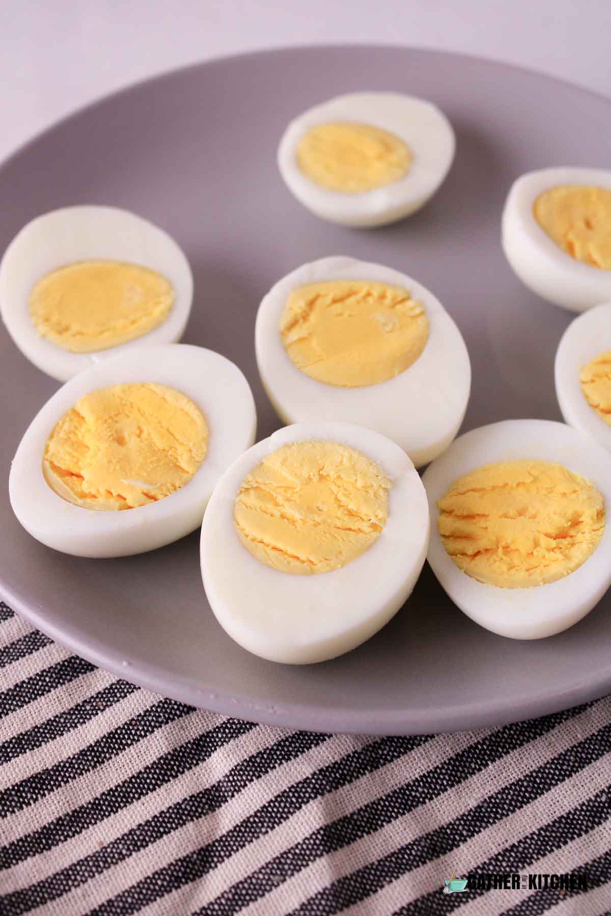 Peeled and cut in half hard boiled eggs on a plate.