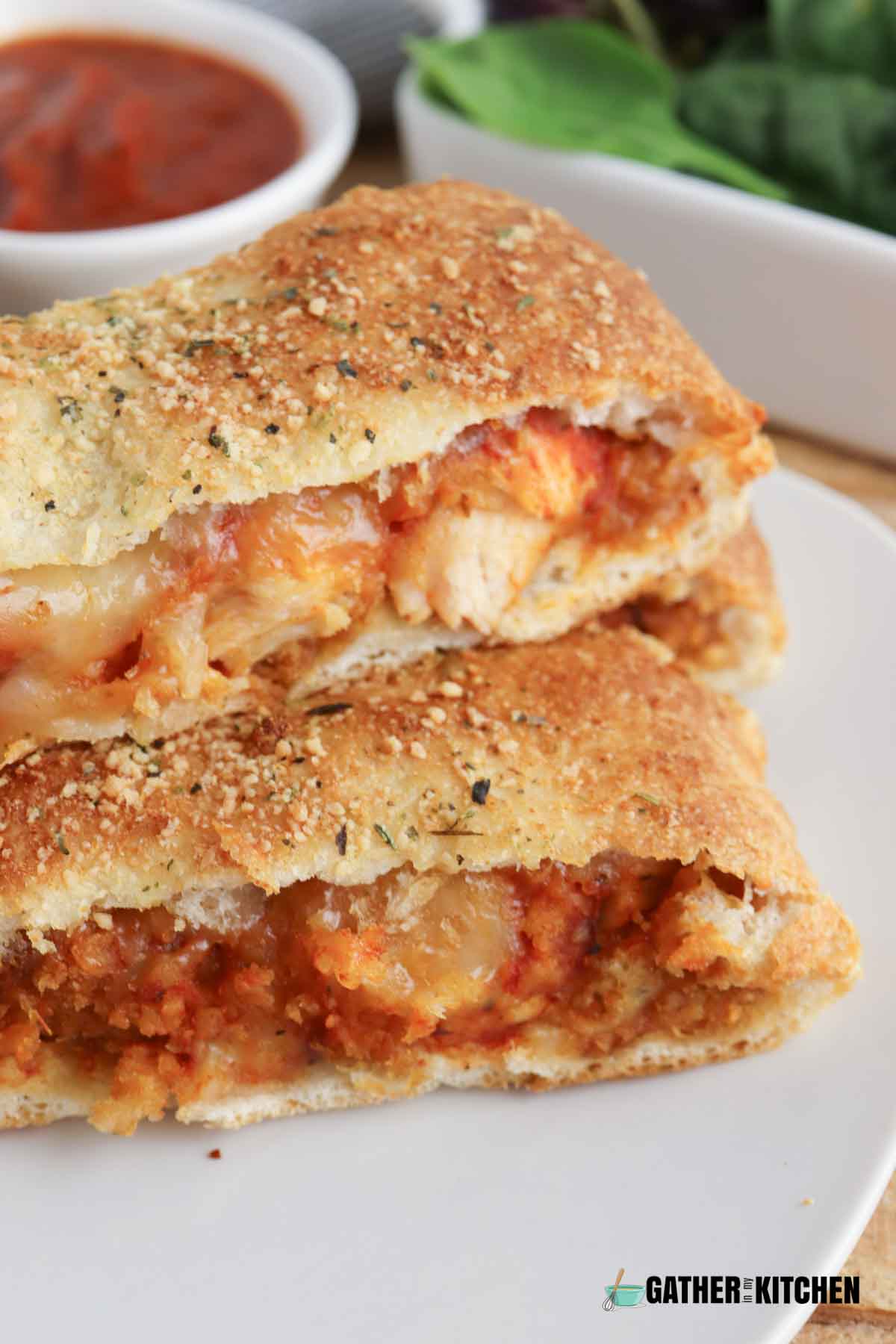 closeup of chicken parmesan stromboli stacked on a plate.