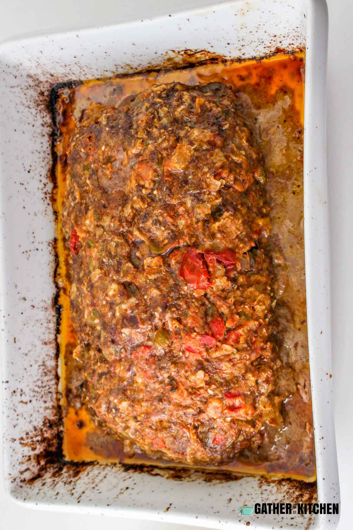 Cooked meatloaf in dish.