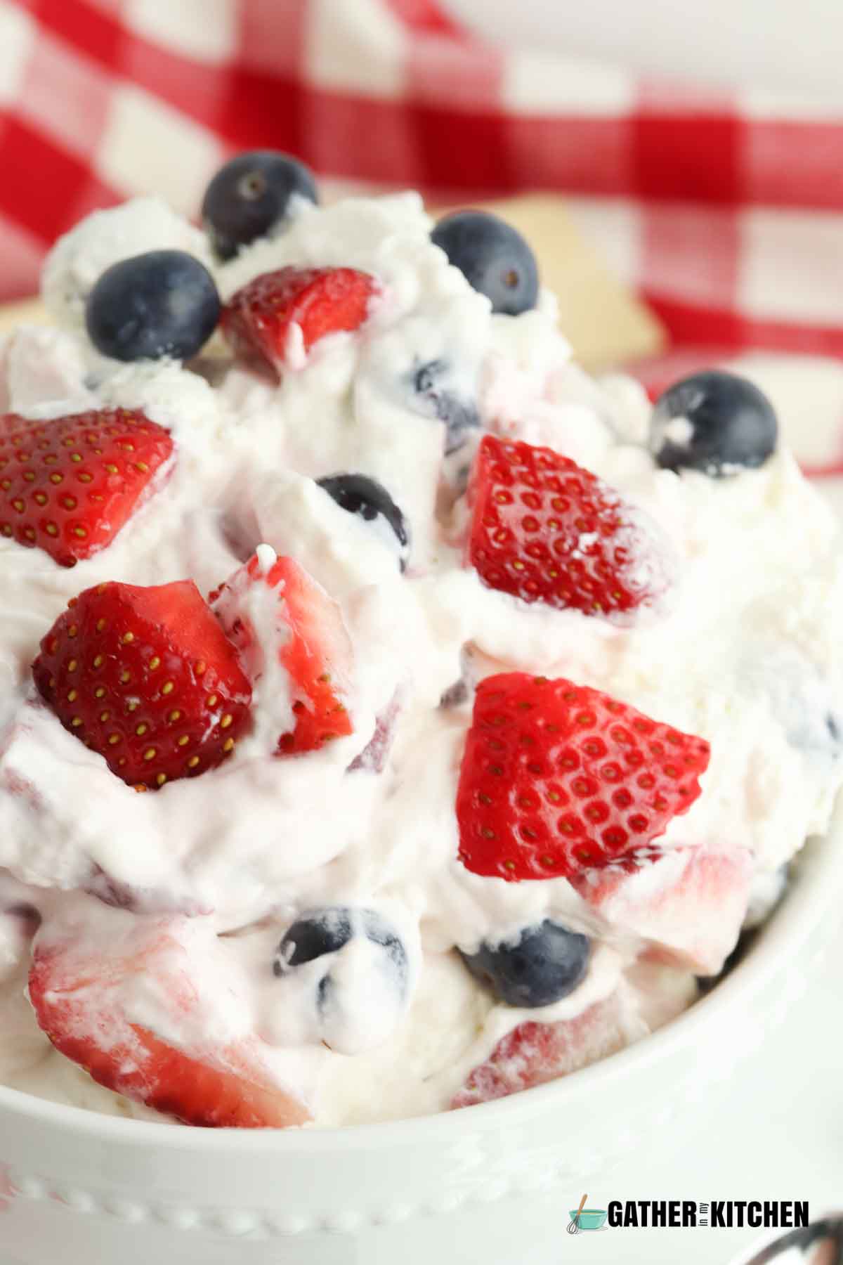 Close up shot of berry cheesecake salad, with strawberries and blueberries being vibrant in color.