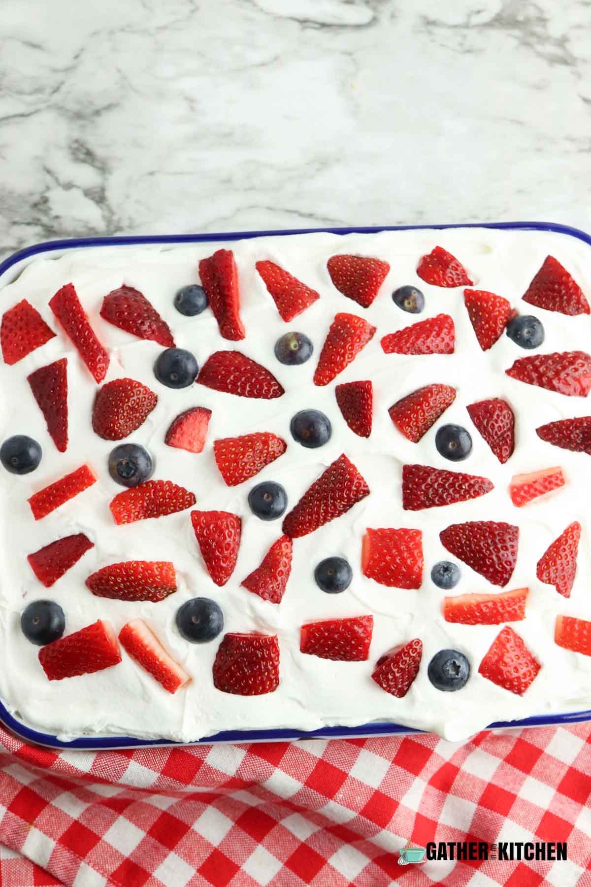 Remaining strawberries and blueberries sprinkled over whipped topping layer.