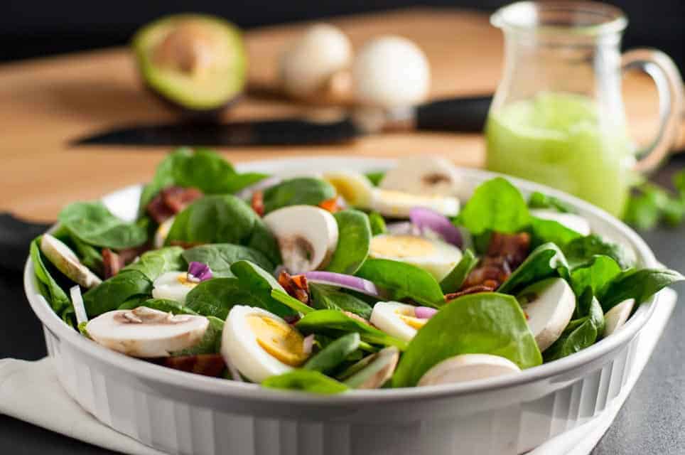 Classic spinach salad in a bowl.