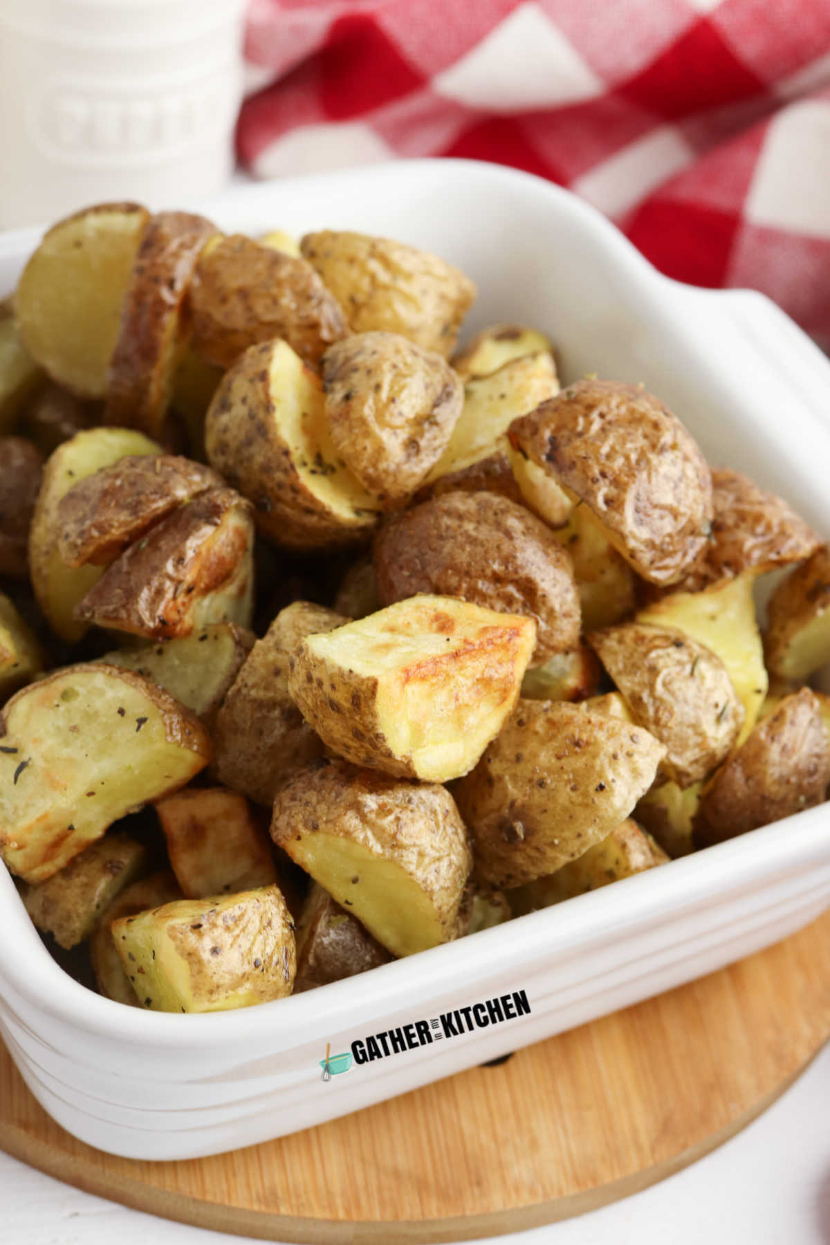 Roasted potatoes in a white dish.