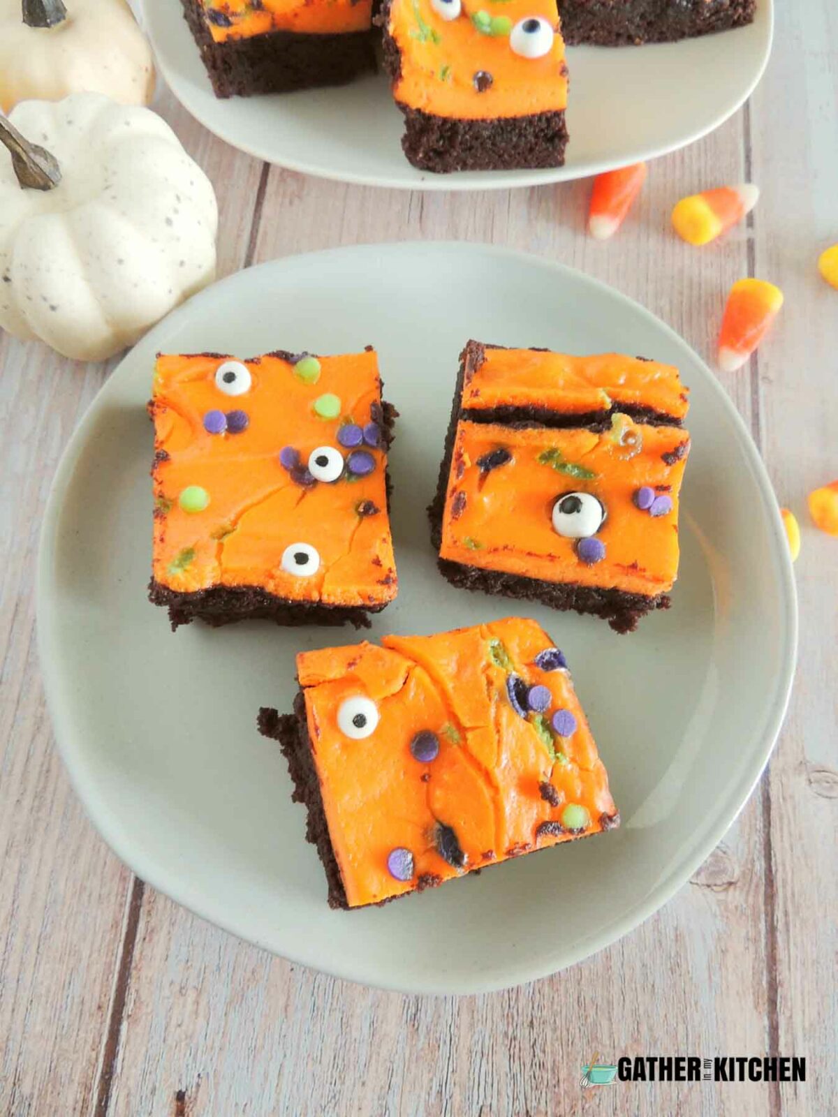 Top view of three pieces of spooky brownies on a plate.