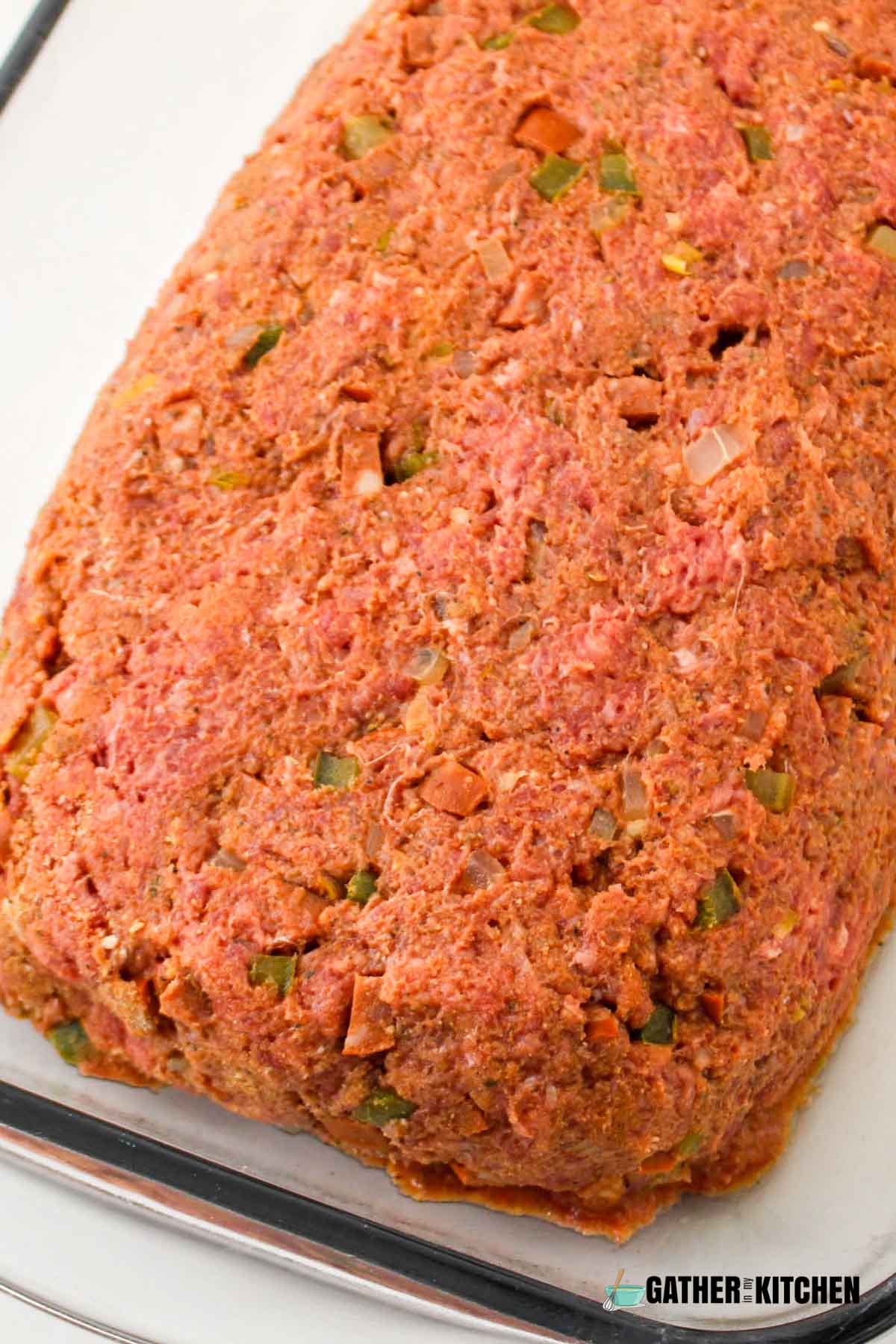 Meat mixture shaped into a meatloaf.