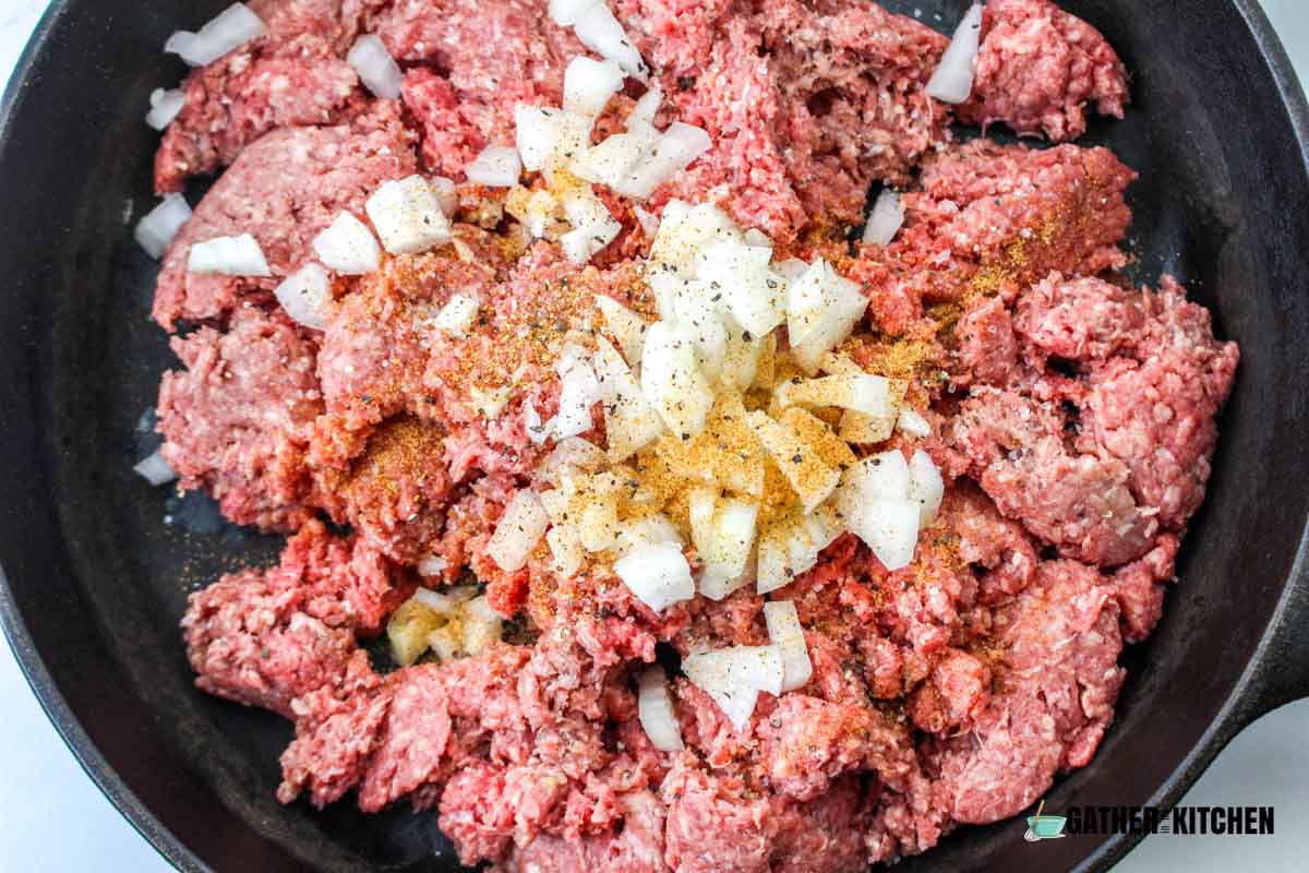 Ground beef, onion and seasonings in a large skillet.