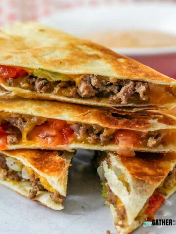 A pile of cheeseburger quesadillas on a plate.