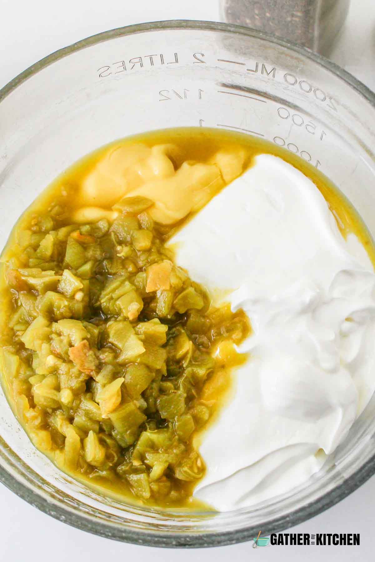Mixture of cream, chilis, and milk in a bowl.