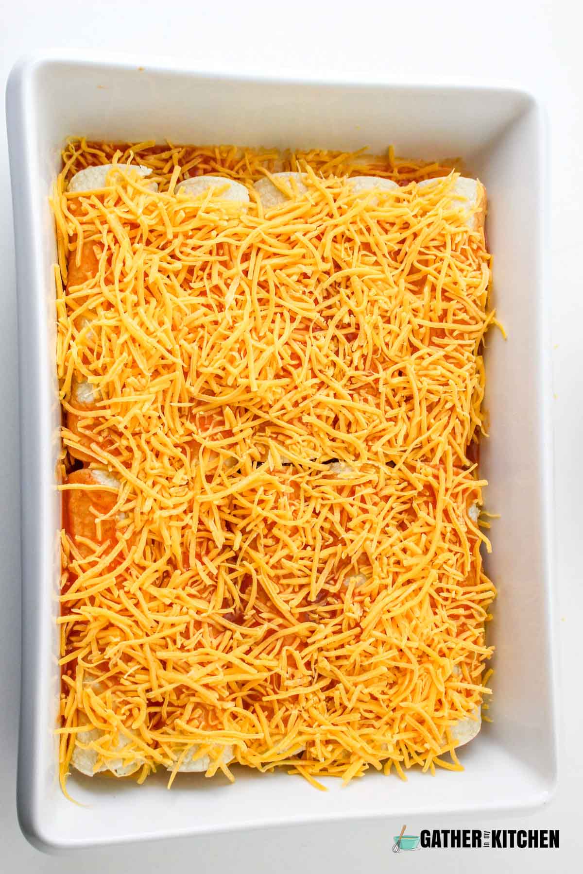 Cheese on top of enchiladas.