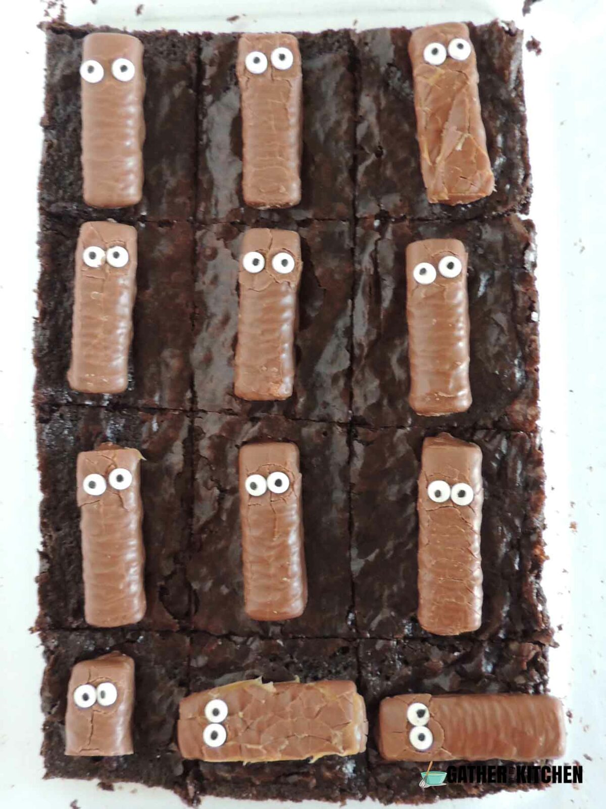 Mini Twix with googly eyes on top of brownies.