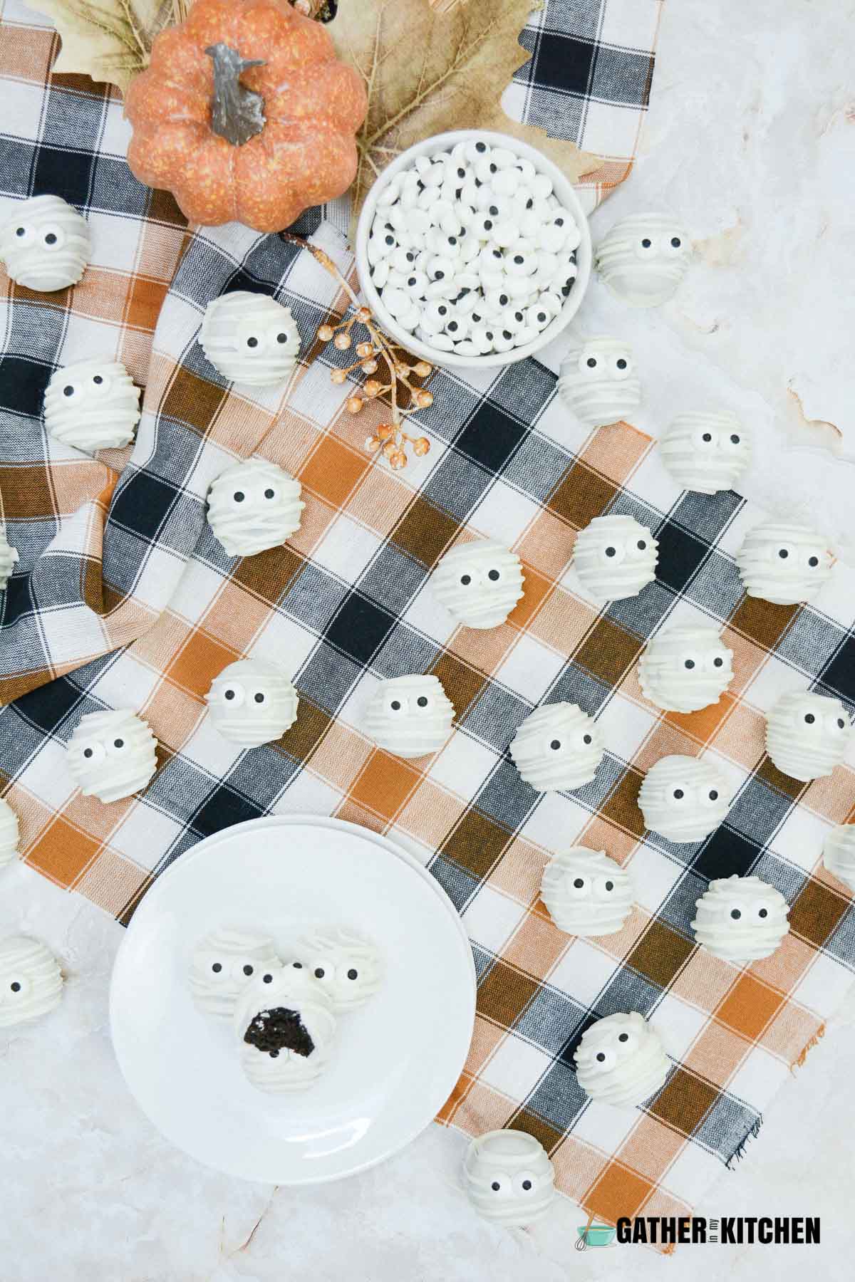 A spread of mummy truffles on a tablecloth and plate.