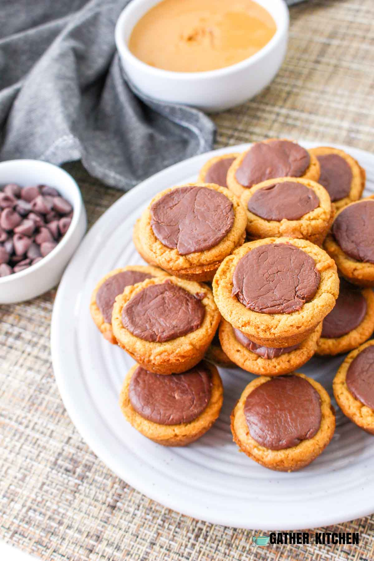Pile of peanut butter fudge cookie cups on a plate.