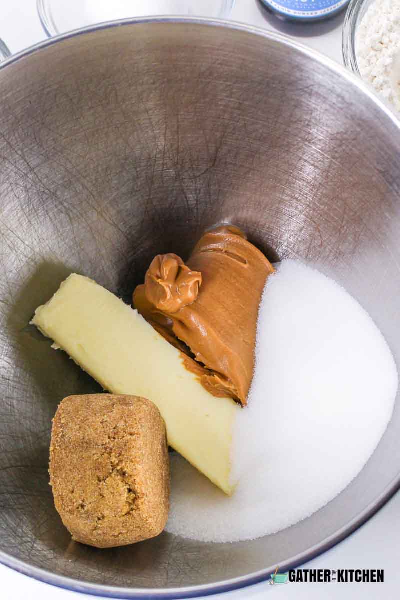 A bowl with butter, peanut butter and sugars in it.