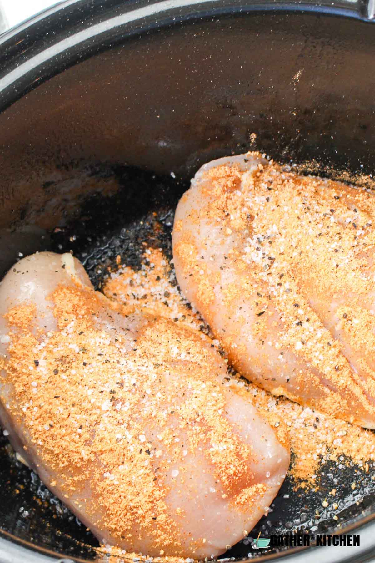 Chicken sprinkled with seasonings.