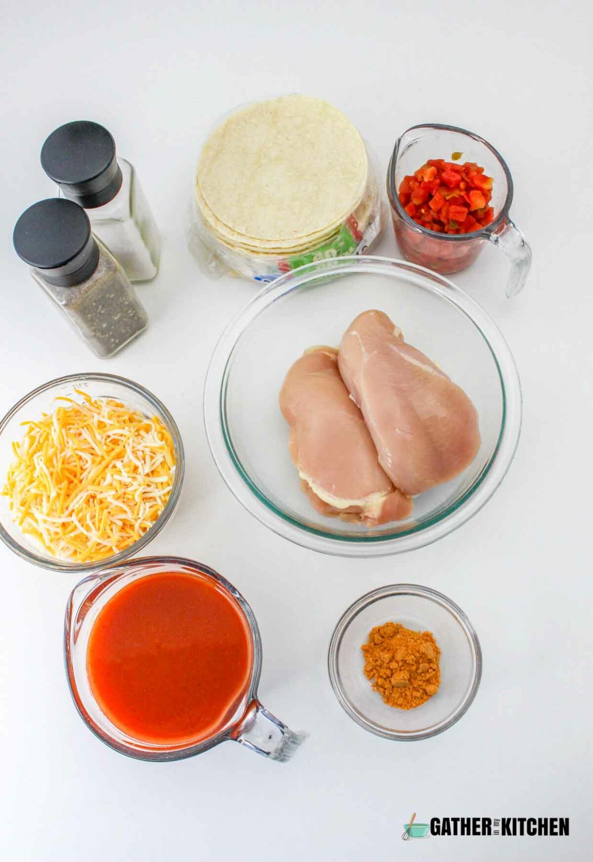 Ingredients for slow cooker enchilada casserole: chicken, taco seasoning, enchilada sauce, tomatoes with green chiles, corn tortillas, fiesta blend cheese.