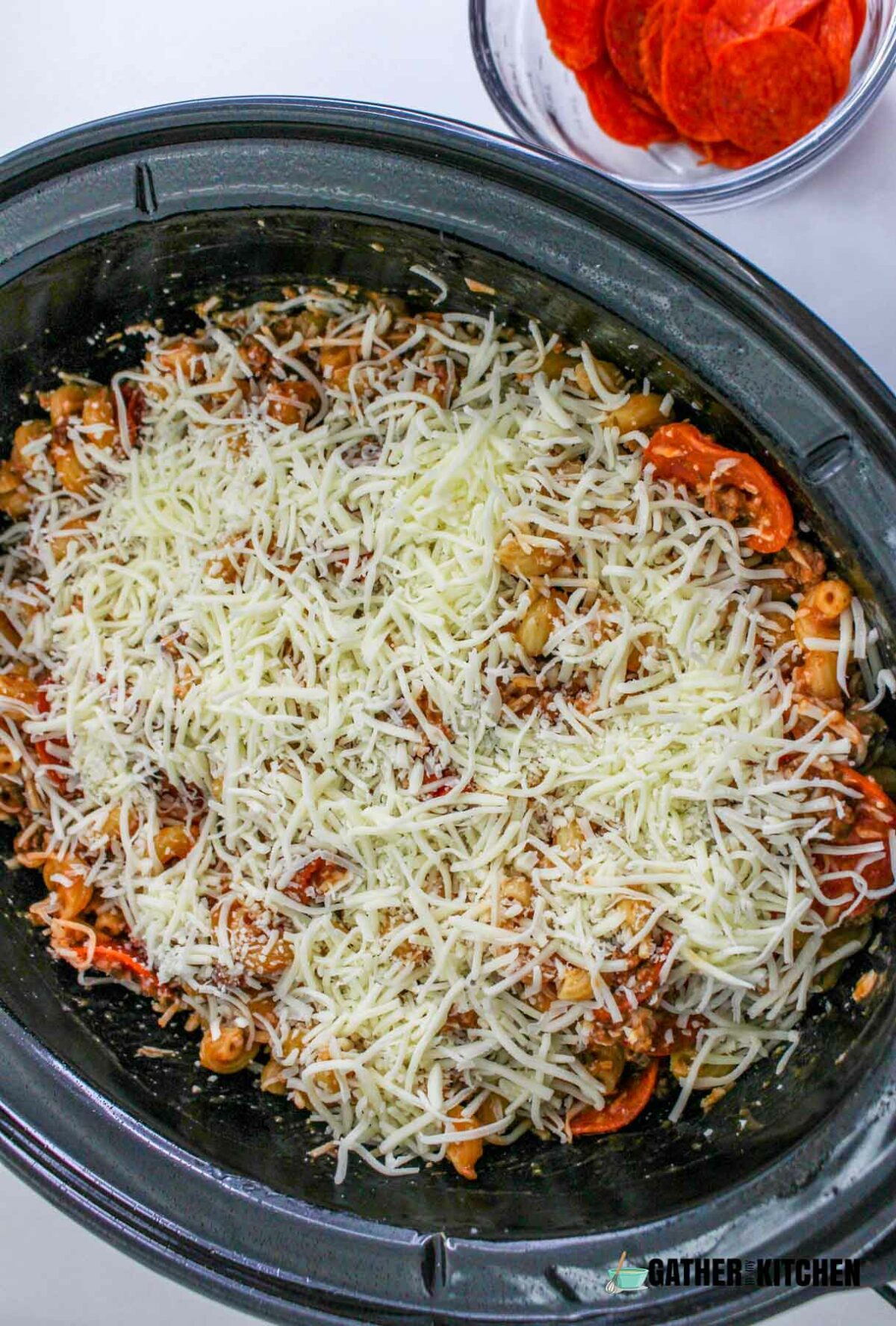 Pizza casserole topped with cheese.