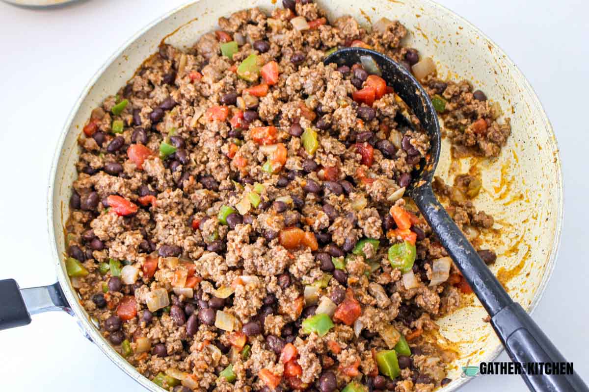 Cooked ground beef with tomatoes, beans and seasonings.