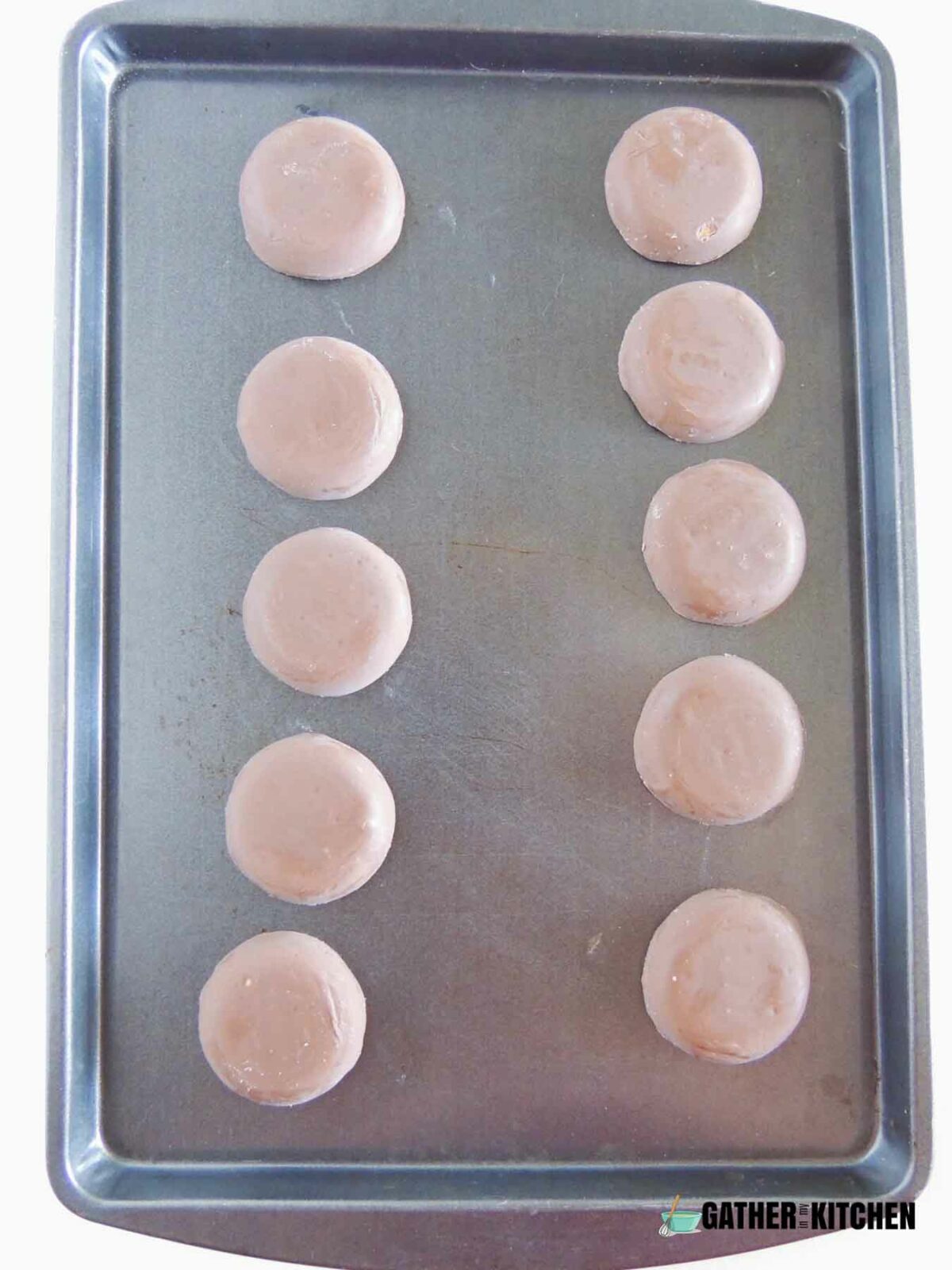 Cookies lined up on a tray.