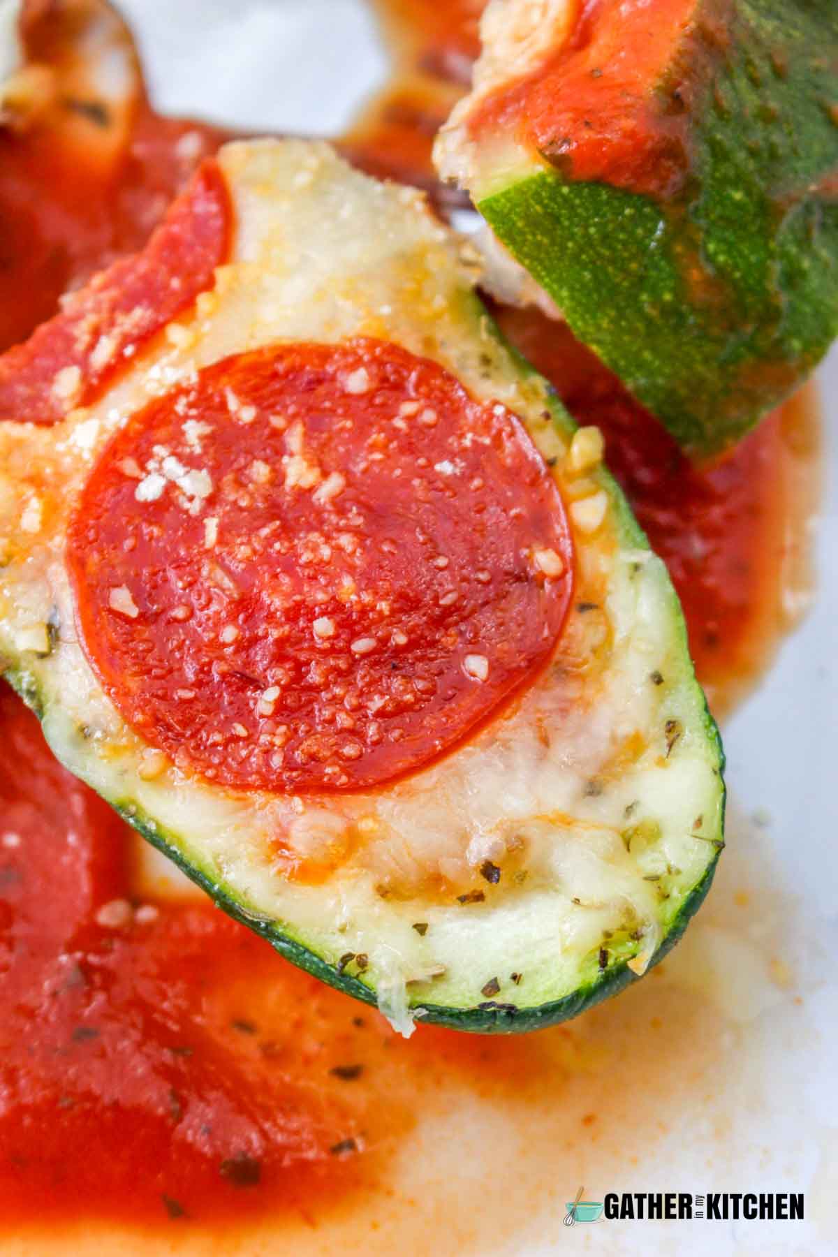Closeup of a stuffed zucchini pizza boat.
