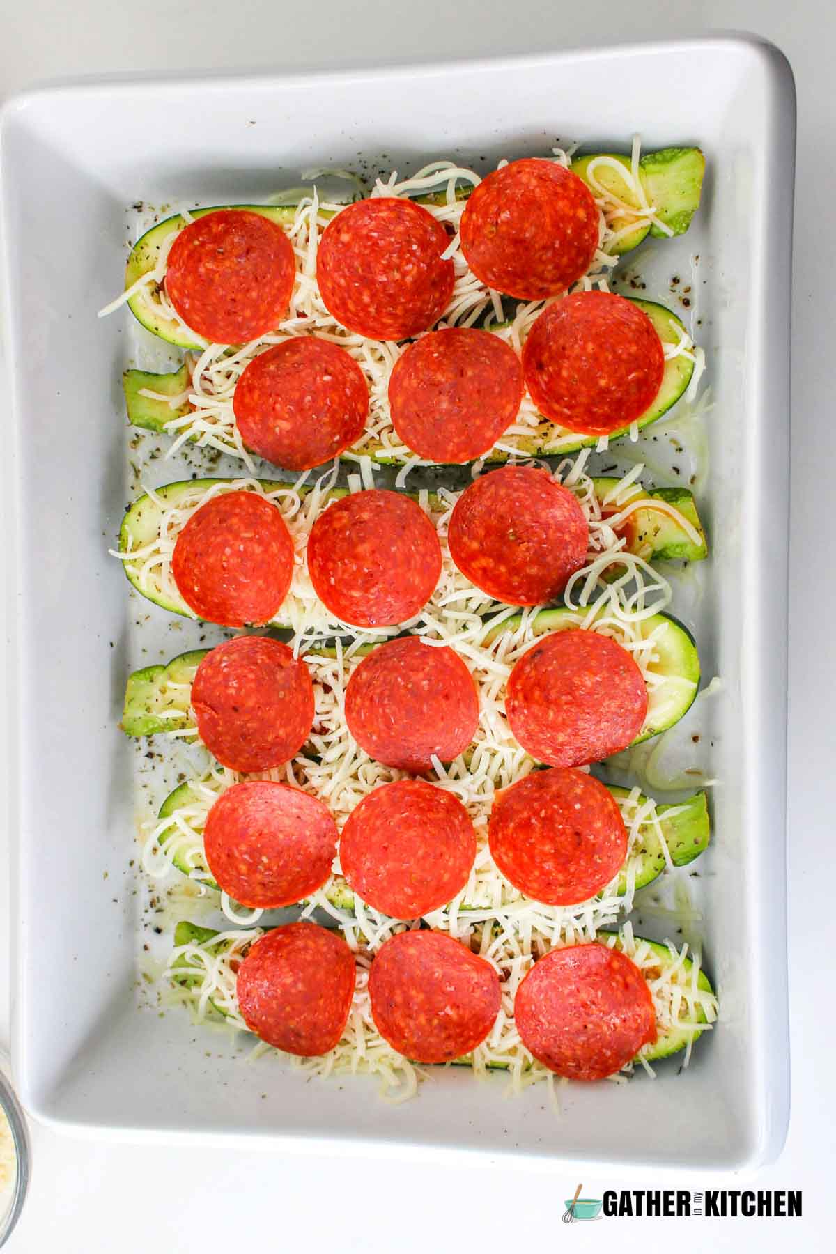 Pepperoni added on top of cheese.