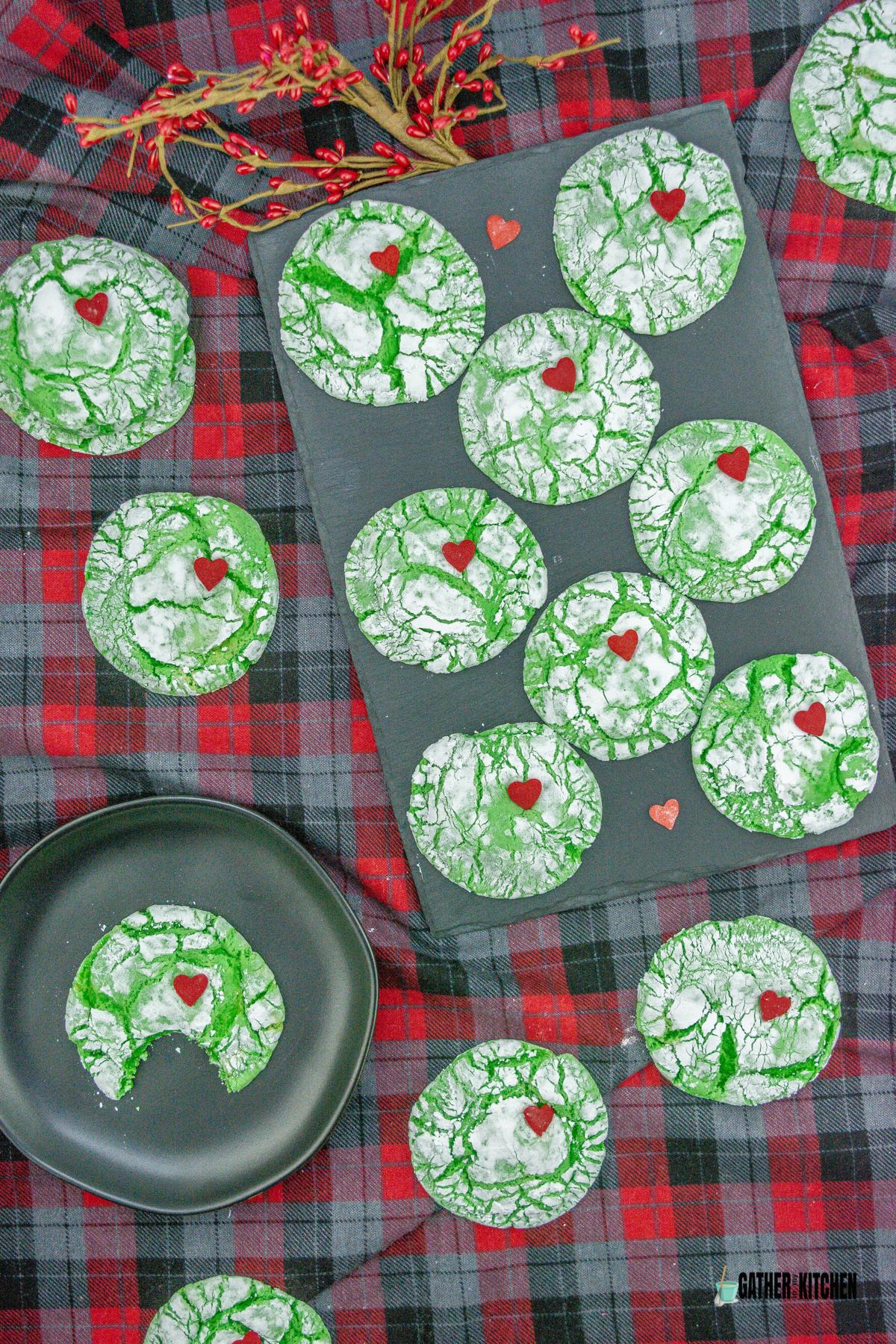Grinch cookies spread out on the table.