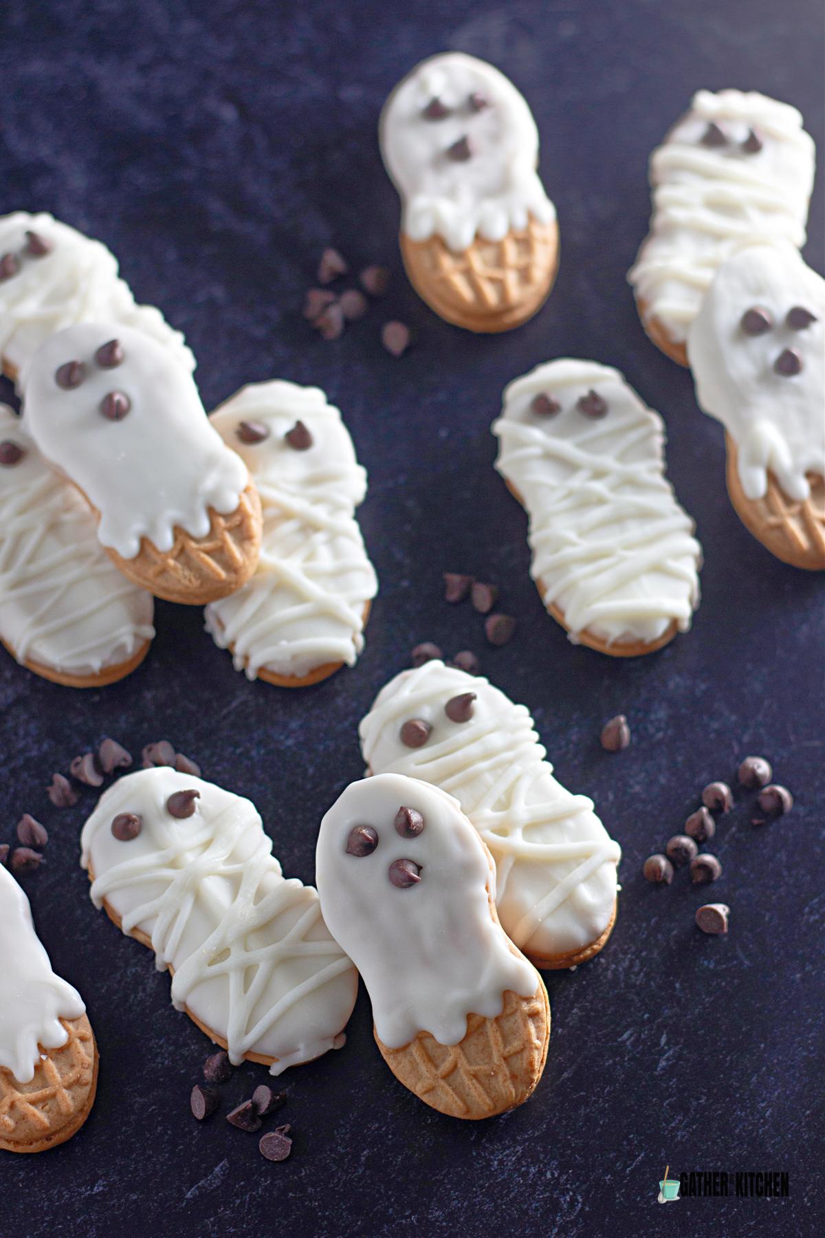 Halloween Nutter Butter Mummy & Ghost Cookies laid out on a table.
